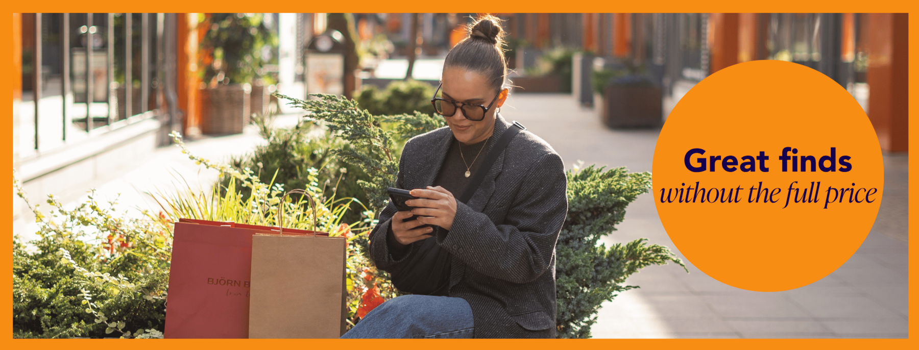 A woman sitting and browsing her phone at Helsinki Outlet