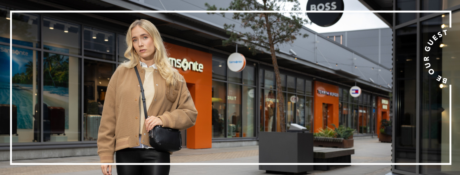 A woman  wearing a beige jacket and visiting in the shopping village