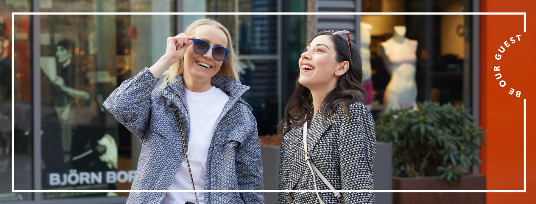 Two women are laughing in the shopping village
